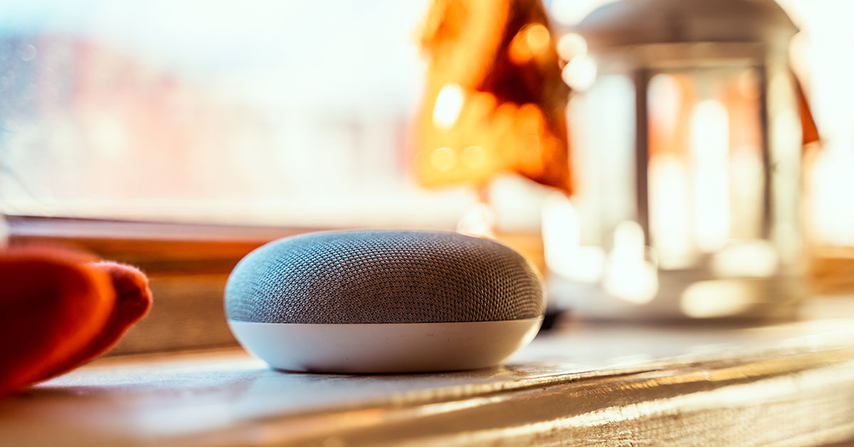 Voice assistant device sitting next to a kitchen window