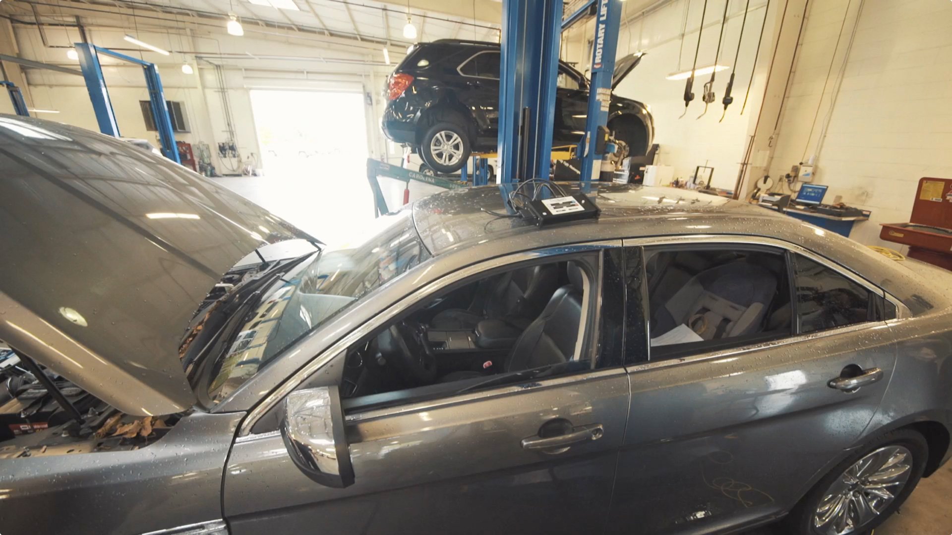 car in a body shop with an asTech device on top of it